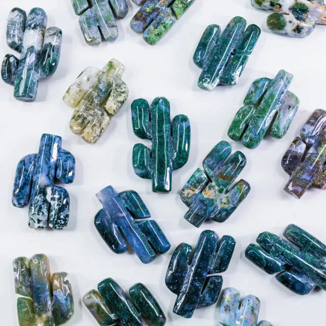 Photo of cactus shaped moss agate crystals on white background